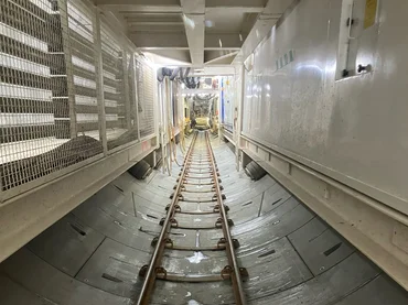 Interior view of a tunnel with narrow-gauge tracks in the centre