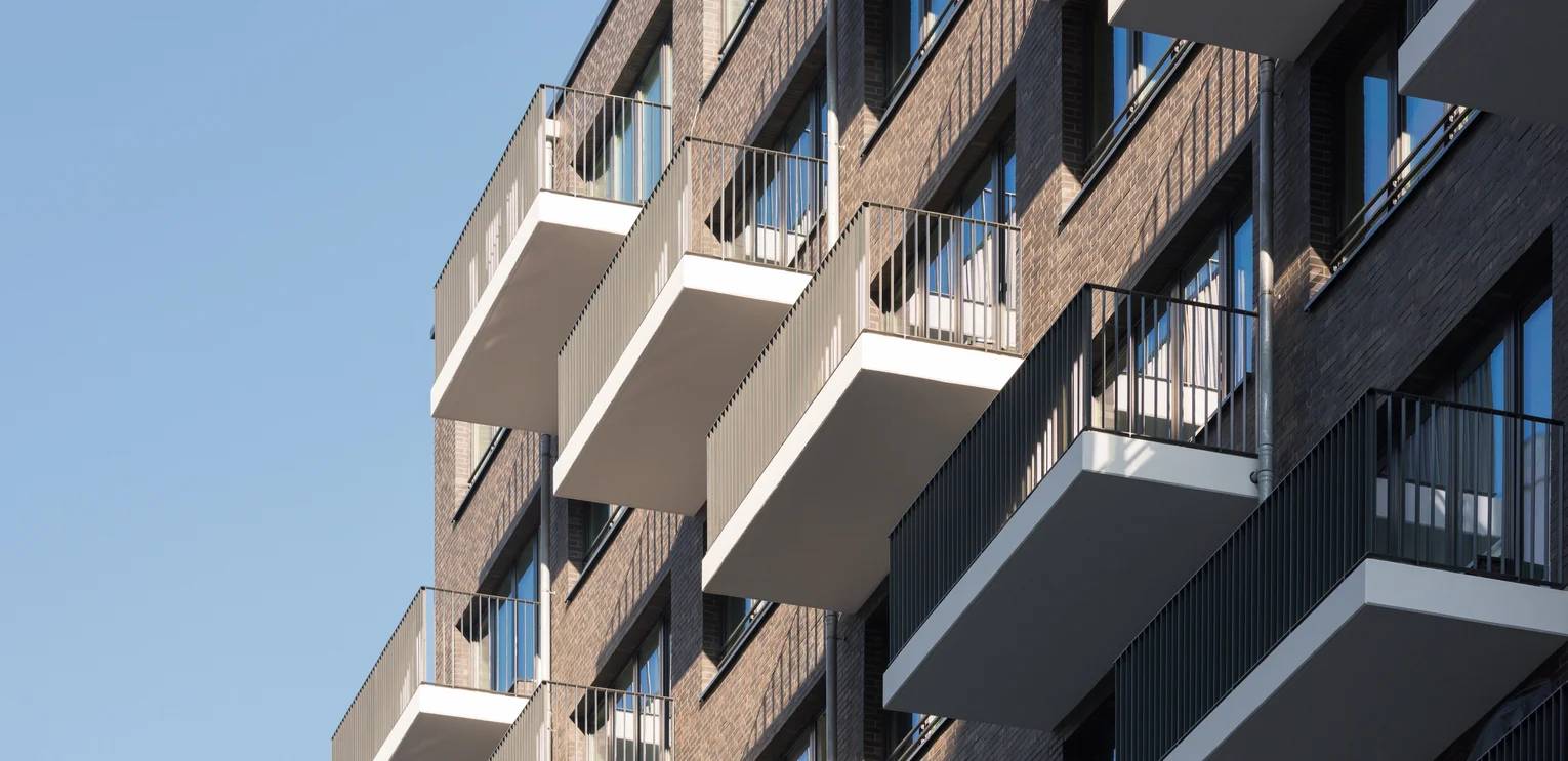 Alexanderplatz residential neighbourhood, Berlin Photo: Residential neighbourhood Alexanderplatz Berlin: Section of a dark building façade with staggered balconies on top of each other