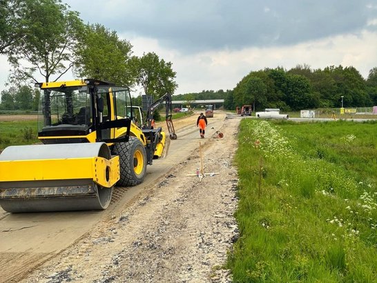 Roadworks on the B70 near Borken, involving the preparation of the road sub-base on an open stretch of road.