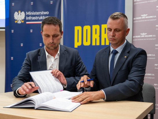 Two businessmen signing a contract